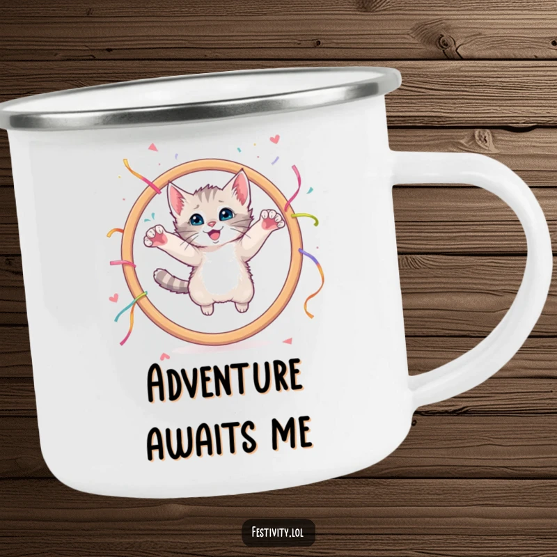 Funny camping mug featuring a curious kitten leaping through a giant hoop adorned with streamers.