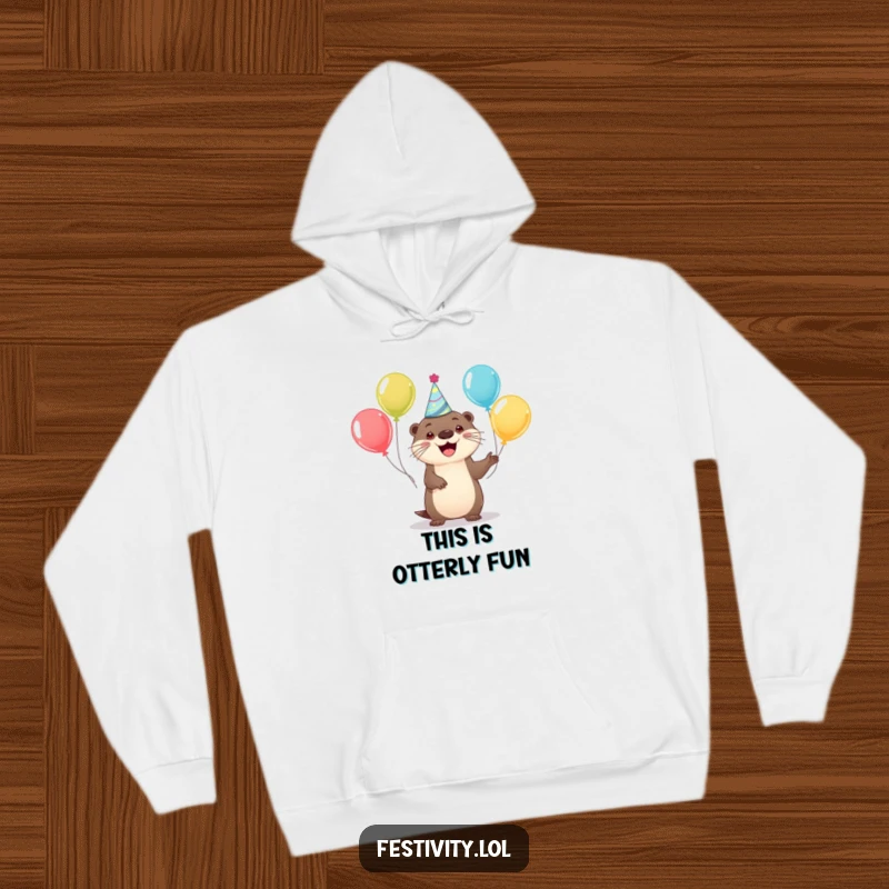 Funny hoodie featuring a happy otter in a party hat juggling balloons, perfect for cozy celebrations and festive moods.
