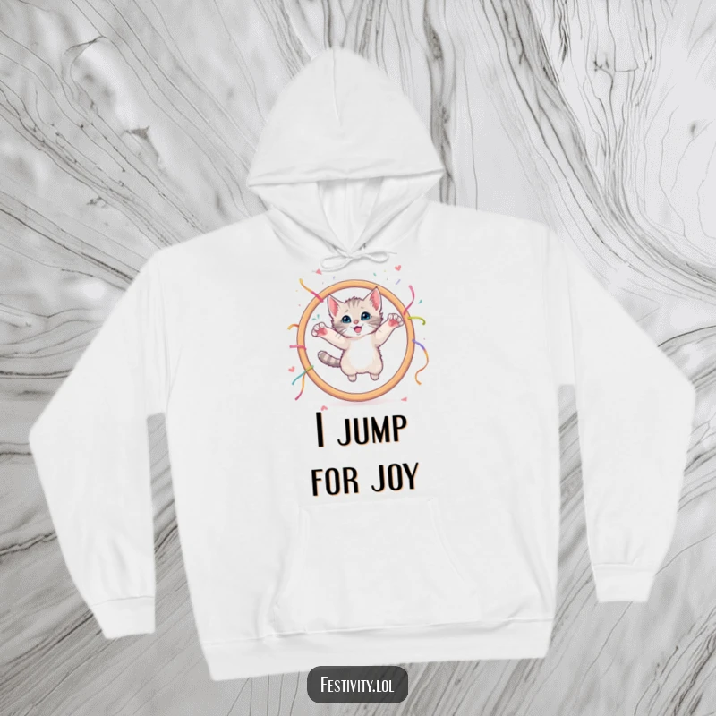 Funny hoodie illustrating a curious kitten joyfully leaping through a large hoop adorned with streamers.