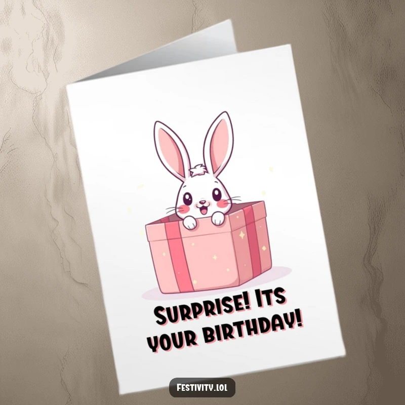 Funny Free Printable birthday card, a cute bunny peeking out surprised from a huge, open gift box, ready for celebration.