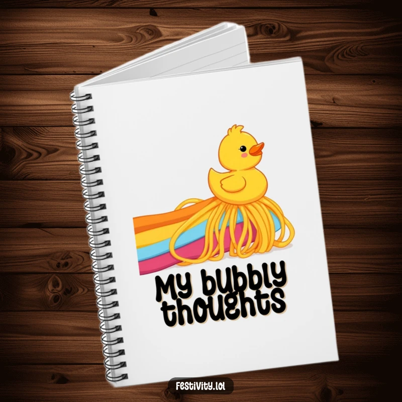 Funny rubber ducky joyfully sliding down a rainbow made of spaghetti, featured on a notebook cover for humorous note-taking.