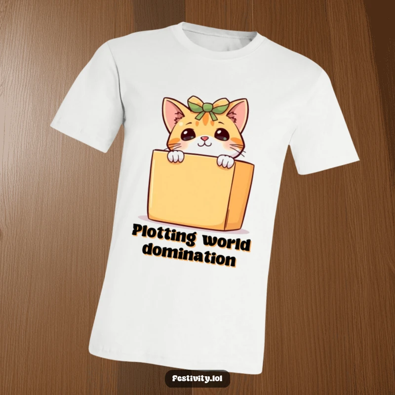 Funny curious cat t-shirt, a sneaky kitten peeking over a large gift box, showcasing its playful and inquisitive nature.